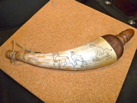 Rotating the horn, the scrimshaw includes an eagle and wolf, ceremonial feathers, an eagle and cougar, ceremonial pipe and shield, war bonnet headdress, and Cheyenne warrior. . Scrimshaw powder horns